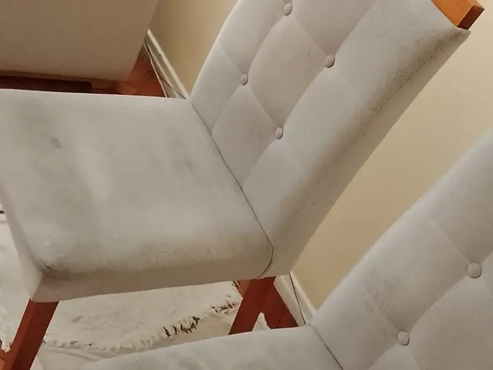 Cadeiras estofadas cinza-claro com manchas escuras no assento e no encosto, antes da limpeza